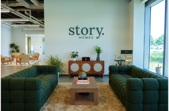 Office building with green sign reading "Story Homes"